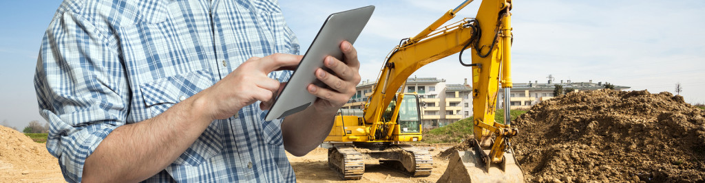 construction worker on tablet using owner insite